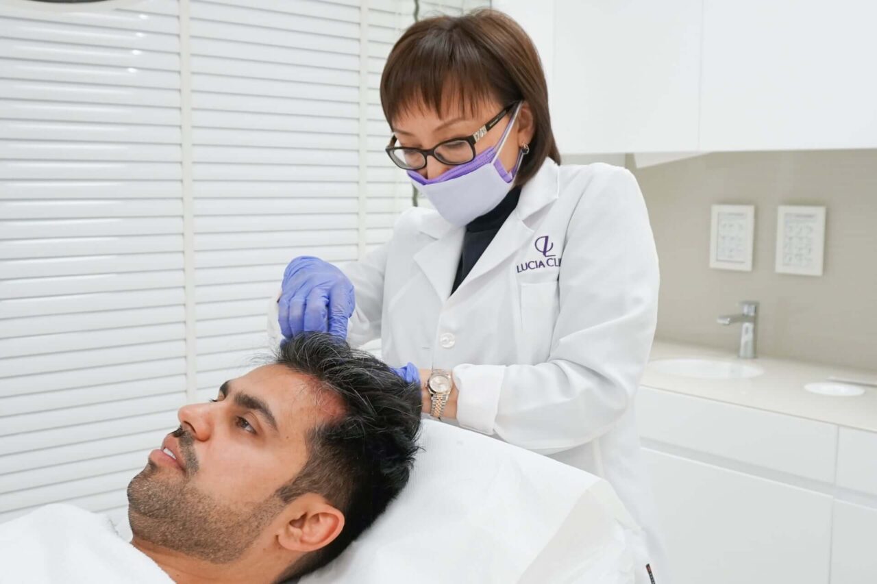 A man getting hair loss treatment at Lucia Clinic