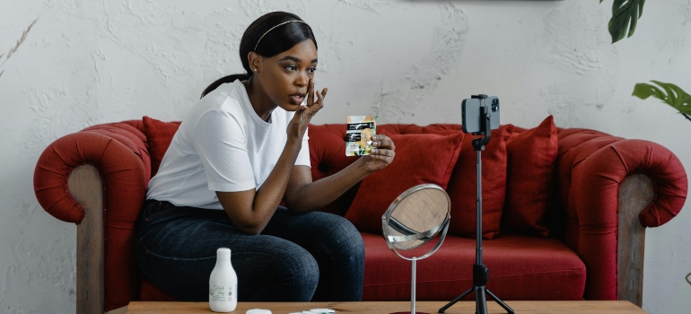 A woman applying skincare to repair sun damaged skin