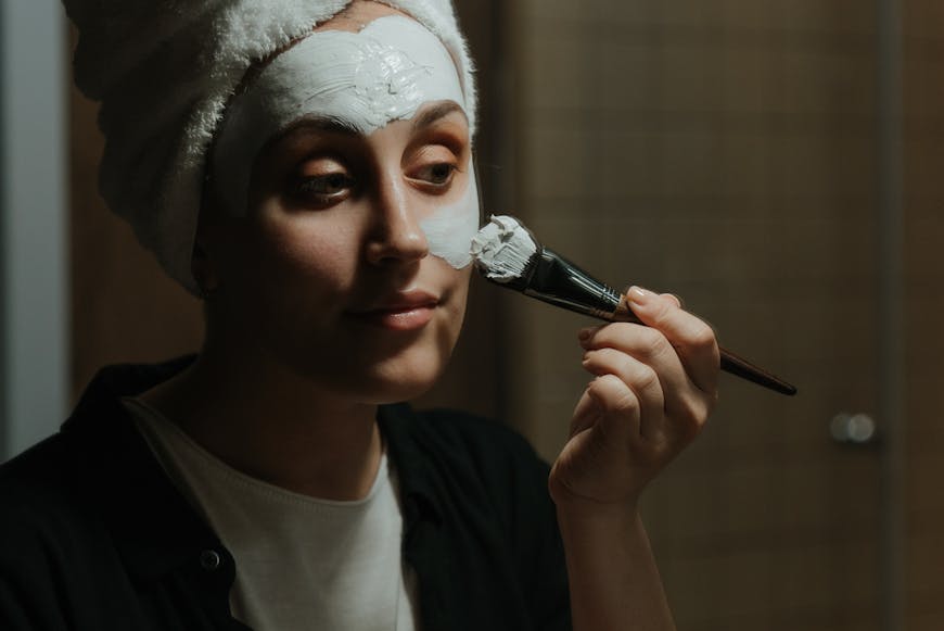 A woman putting her face mask