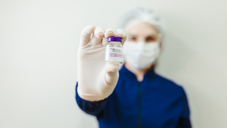 A doctor holding a Botox vial