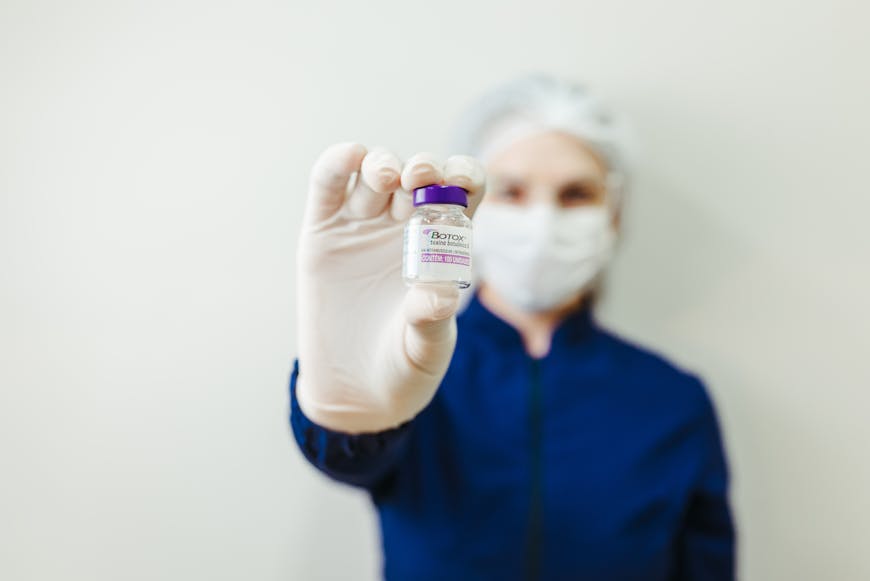 A woman holding a Botox vial