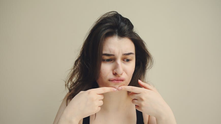 A woman frowning and touching her chin