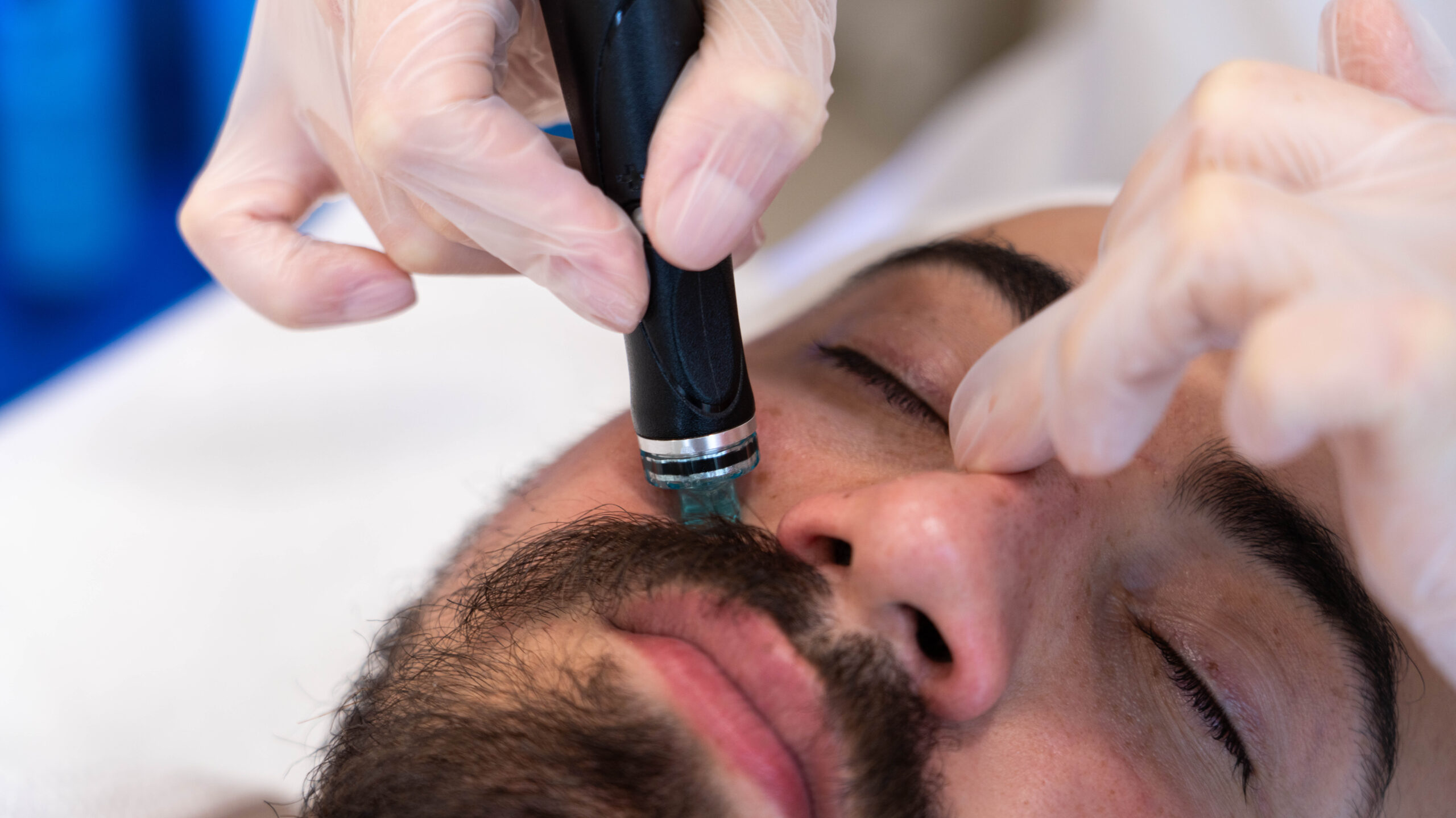 A man getting a face treatment