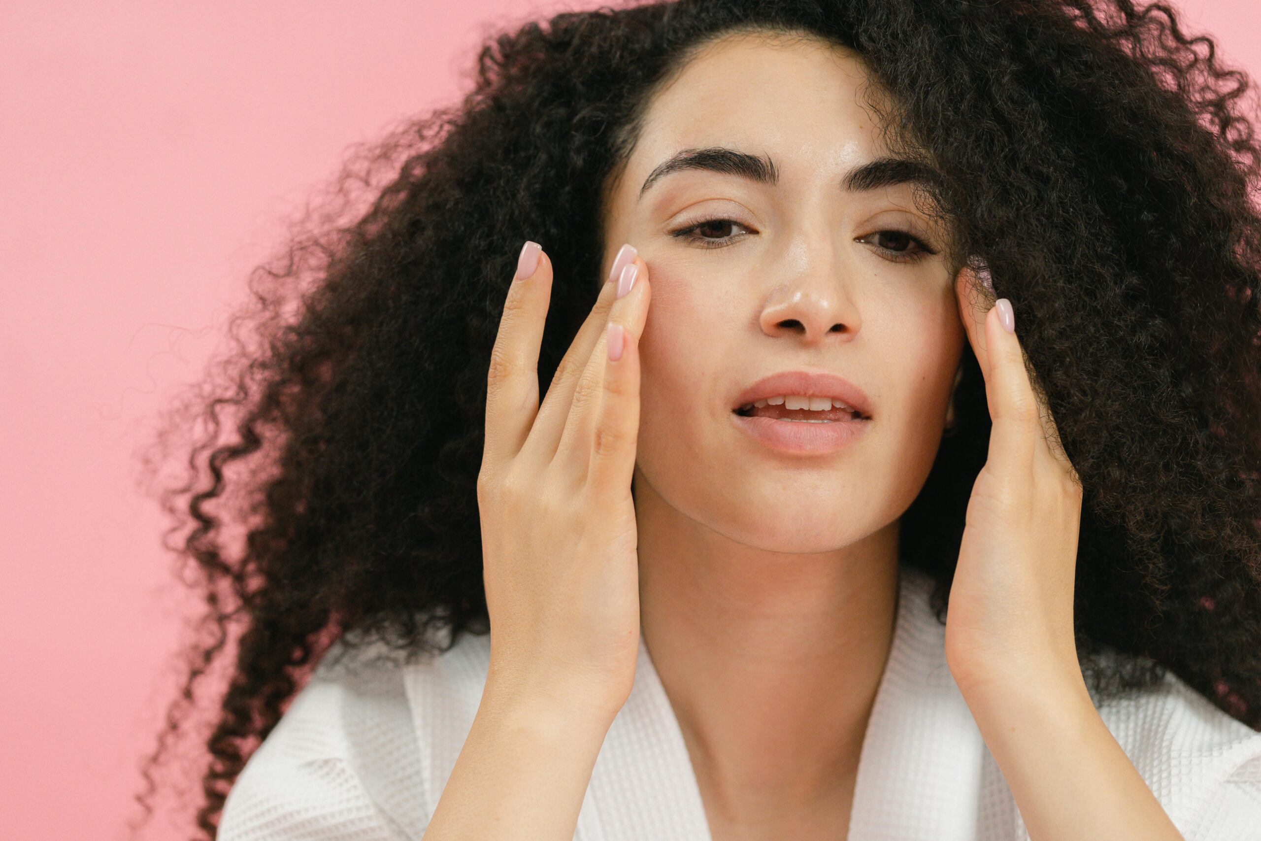 Woman Putting Face Cream on Cheeks