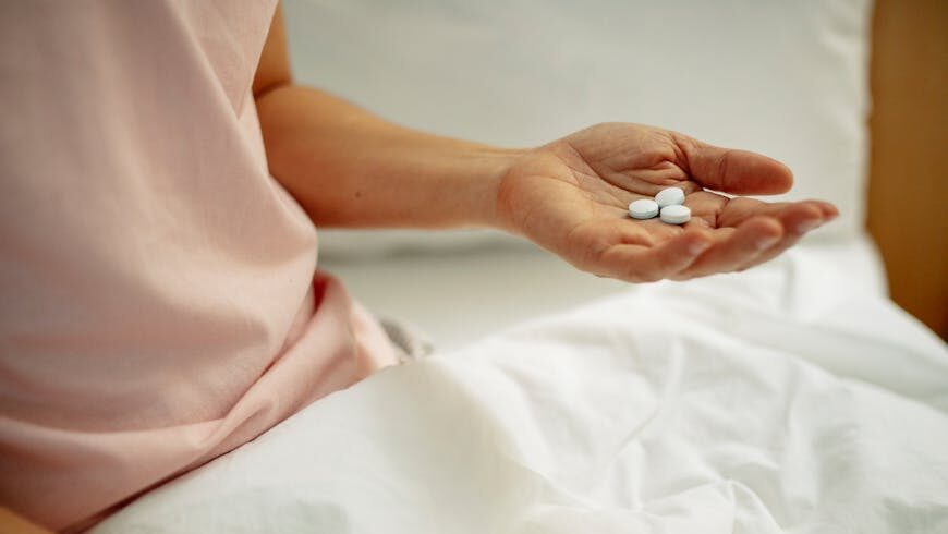 A person holding pills during BBL recovery time