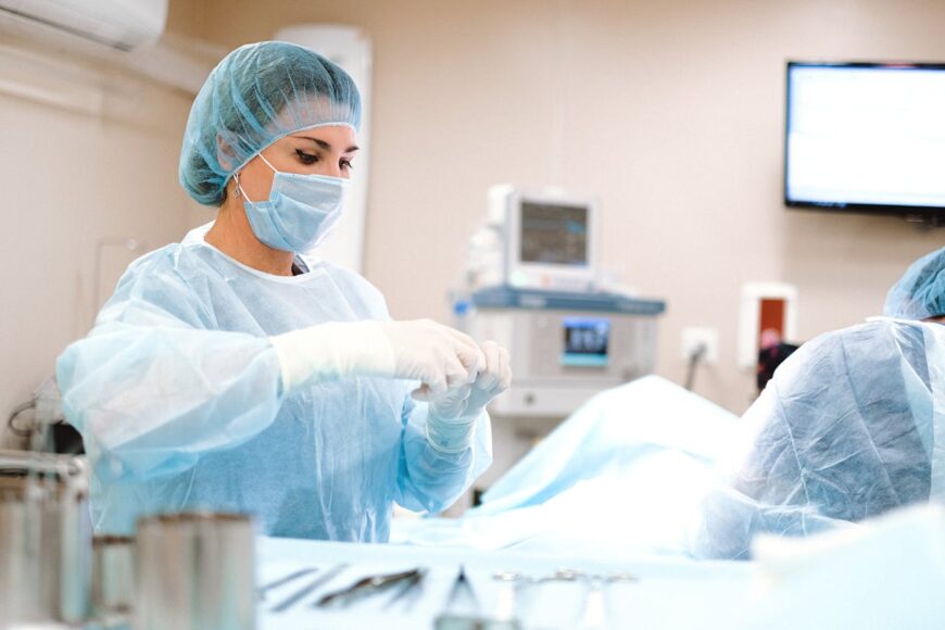 Female doctor in scrubs performing surgery 