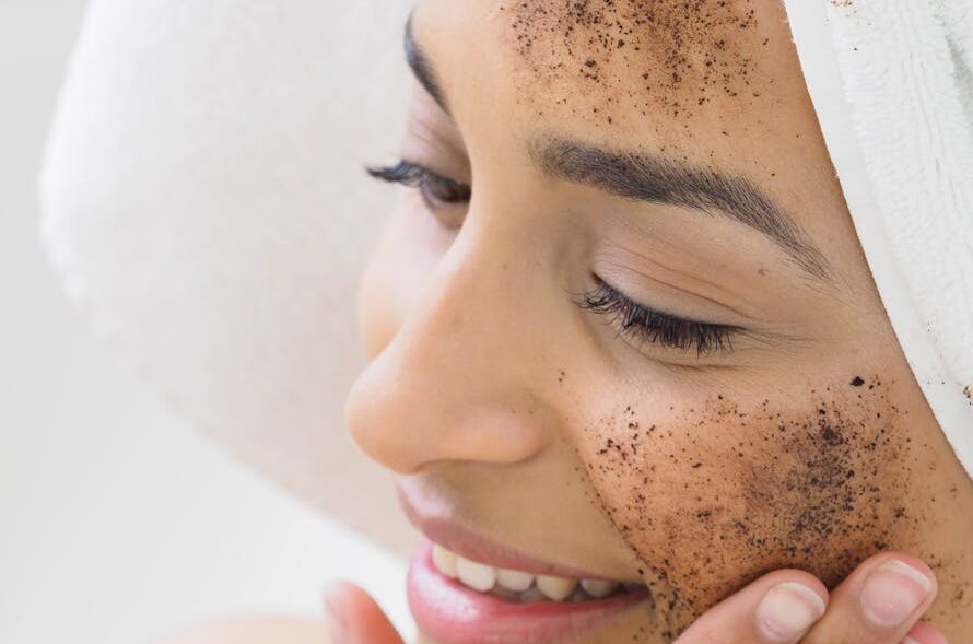 A woman putting a mask on her face