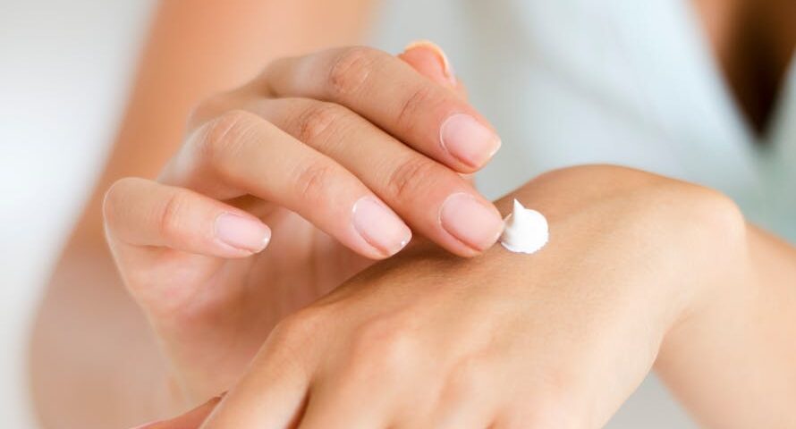 A woman applying sunscreen