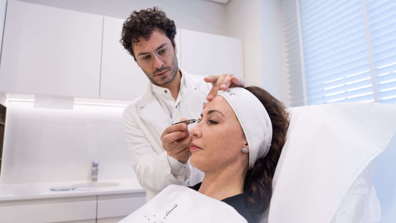 A doctor at Lucia Clinic helping his patient recognize eye aging signs