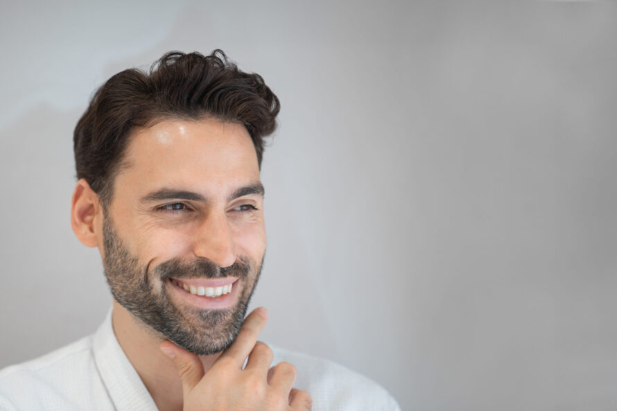 A man after listening to expert tips to maintain the glow after a laser treatment at Lucia Clinic
