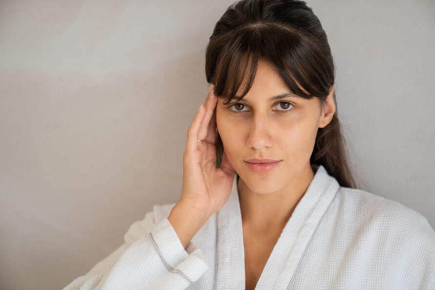 A woman touching her face