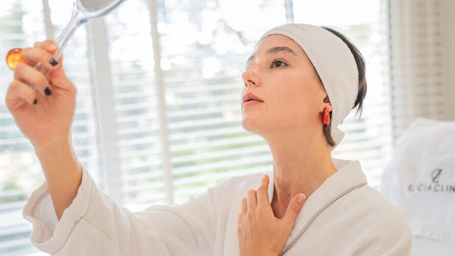 A woman looking at her neck