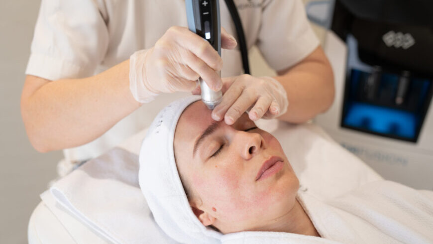 A woman getting EMFUSION treatment at Lucia Clinic.