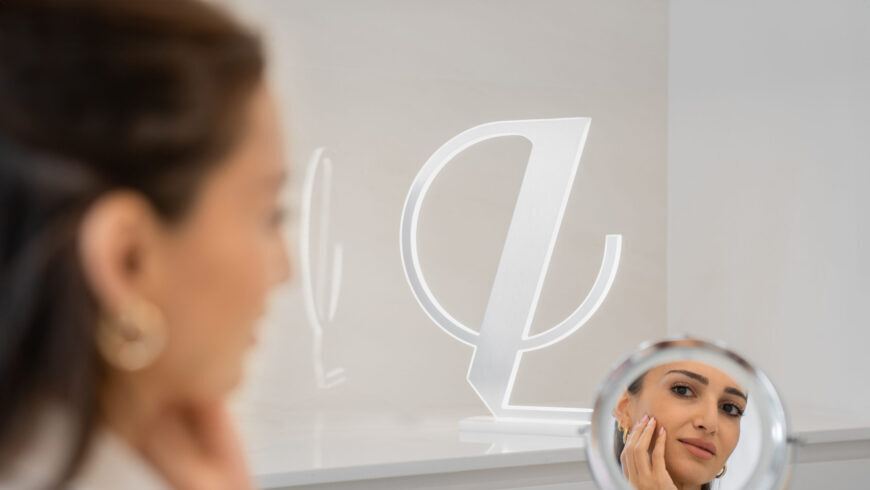 A woman looking at a mirror before a procedure